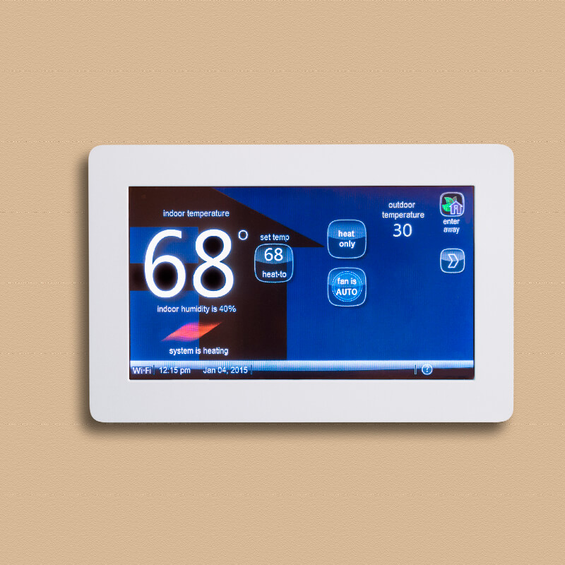 a white Digital thermostat displaying temperature on a cream wall