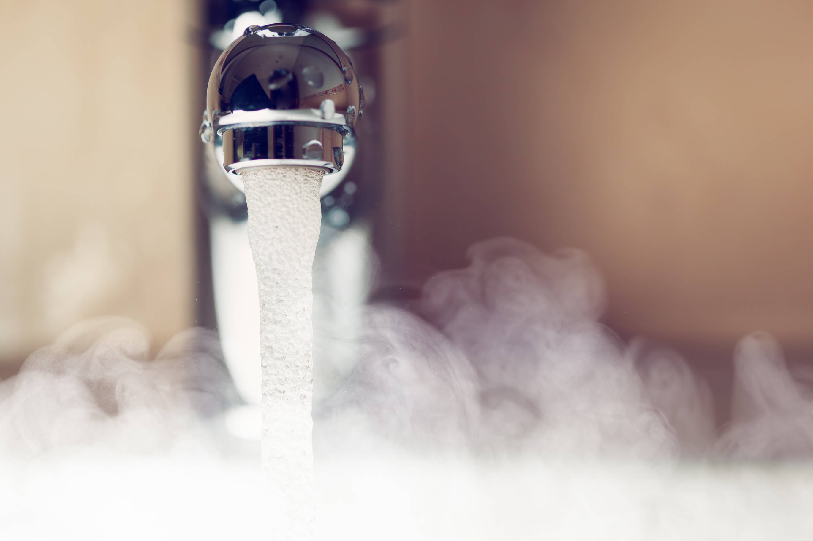 Steaming hot water coming out of tap