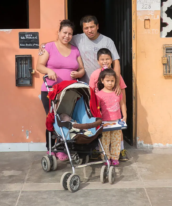 Peruvian family in front of their home