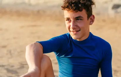 Young boy blue shirt on beach
