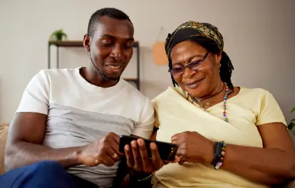 Son with mom looking at phone