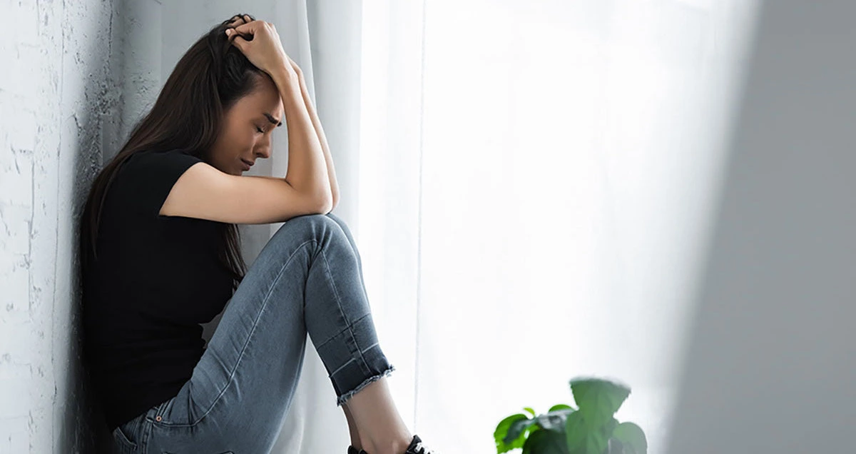 Teen crying alone because of mental health challenges