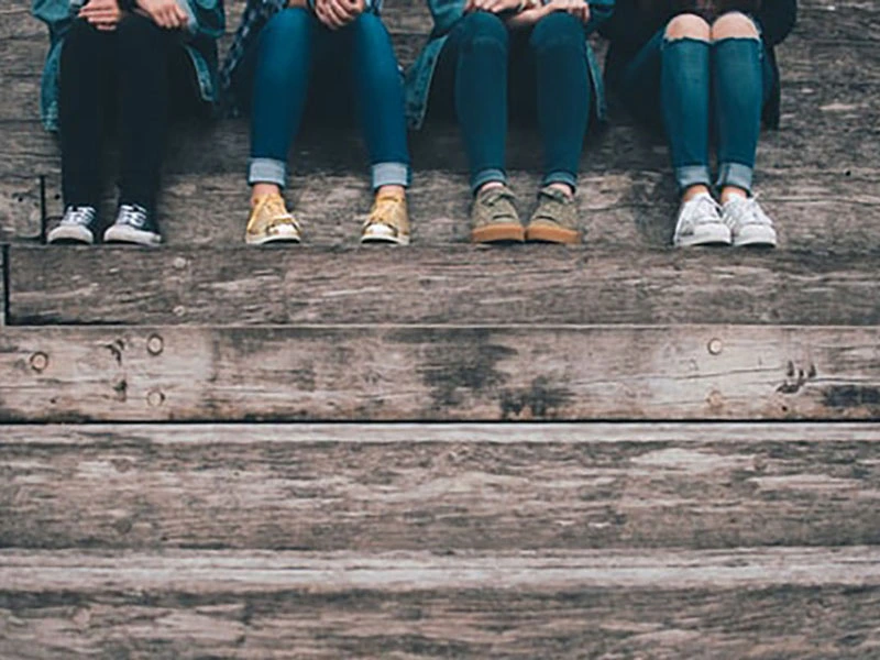 teens sitting on staircase chatting