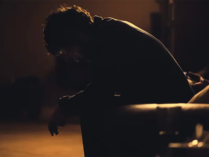 Student sitting alone in the dark