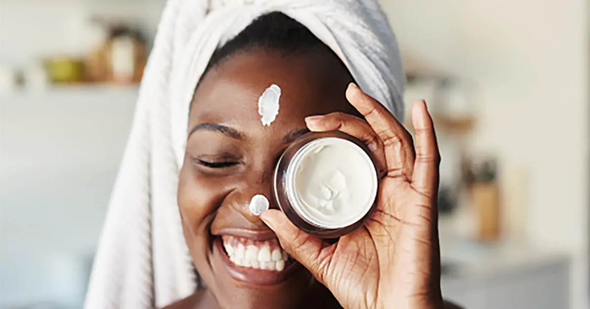 Teen putting on skin lotion while enjoying a self-care day