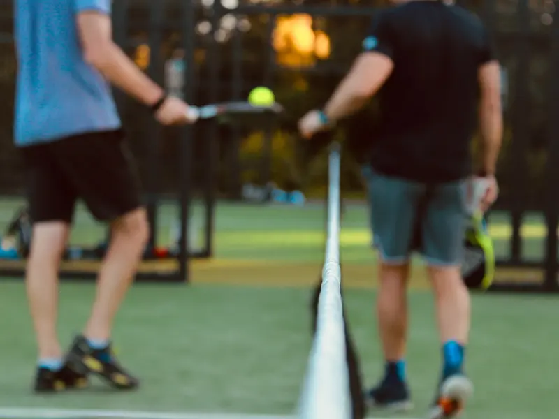 two young men playing tennis