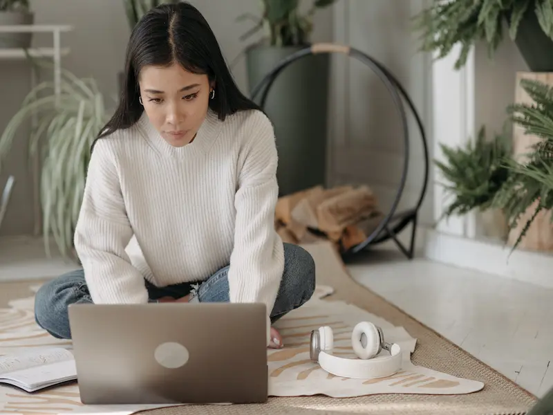 Young woman reading about the mental health crisis on her computer