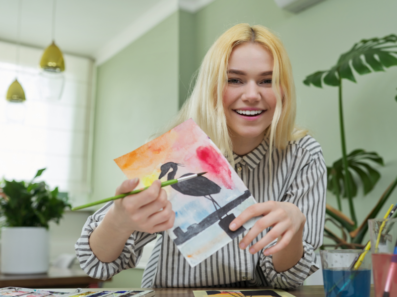 Teen girl showing her drawing that she did in experiential therapy