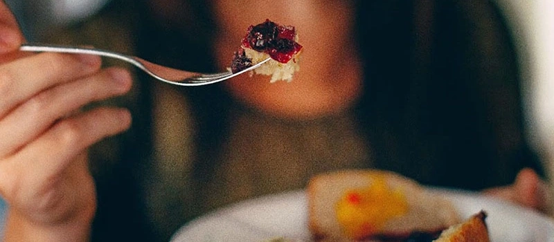 Person eating a pastry