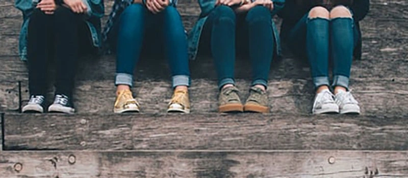 teens sitting on staircase chatting