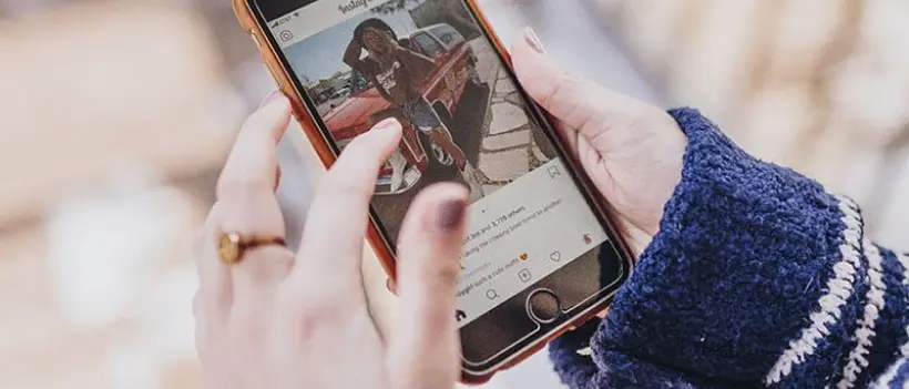 A teen scrolls through social media
