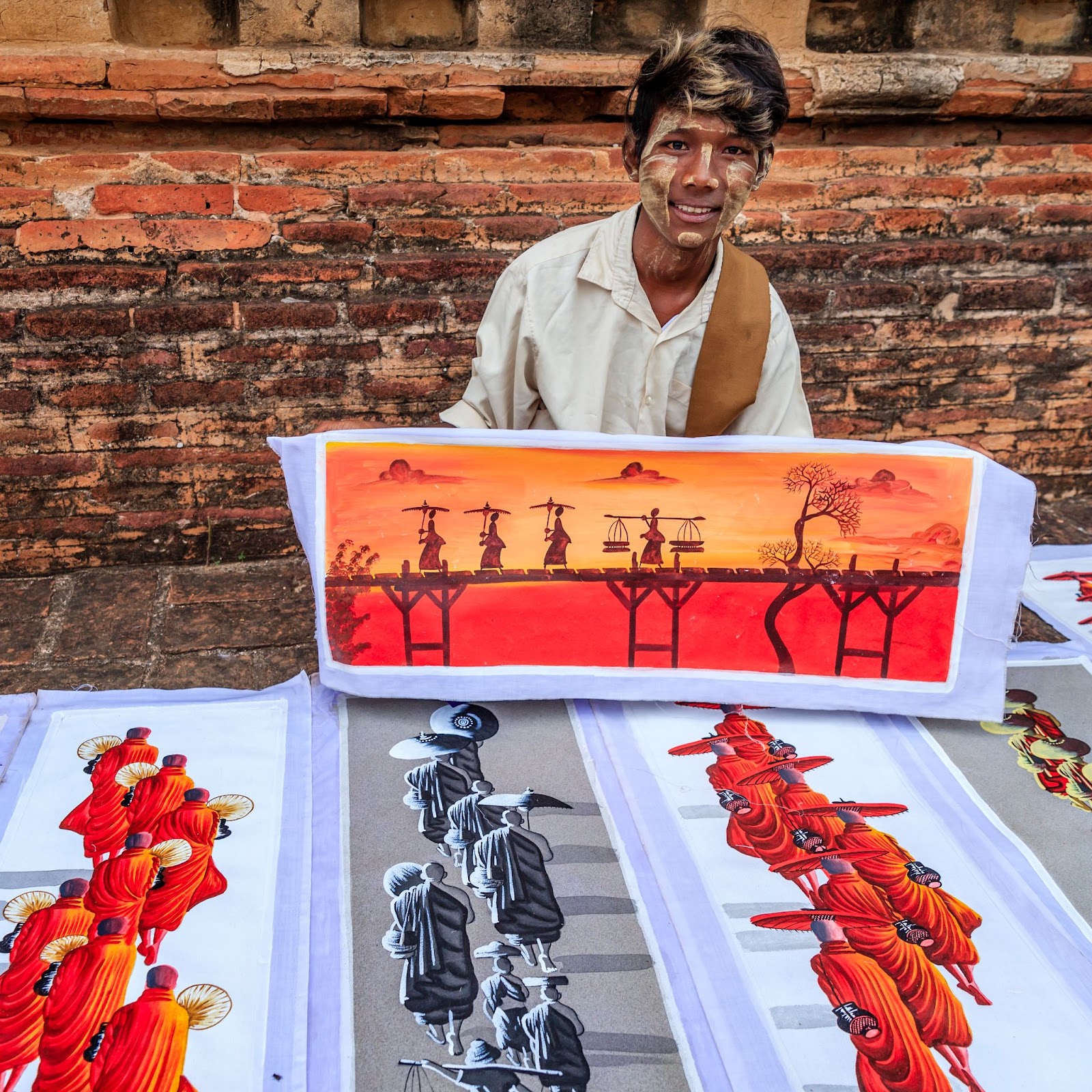 Shop owner displaying his hand-painting 