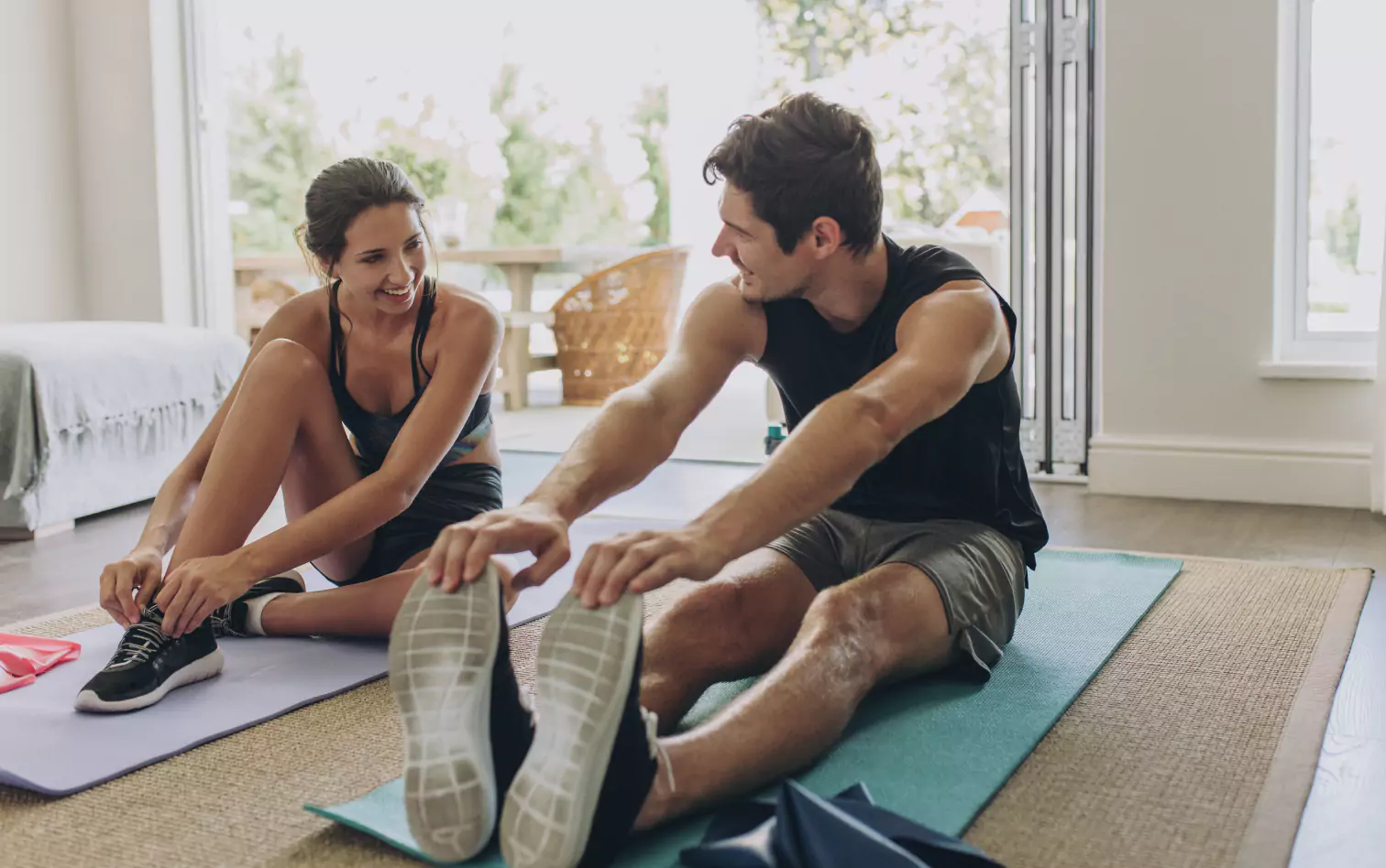 two people stretching at home