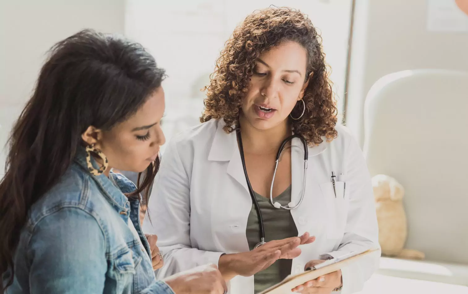 A woman at the doctor's office, getting a consultation