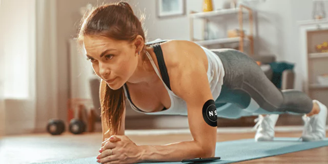 a person working out at home, wearing CGM