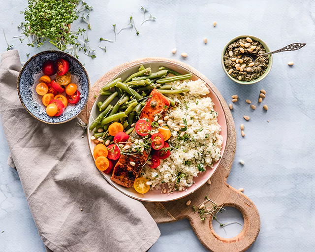 a plate of porridge, veggies and meat