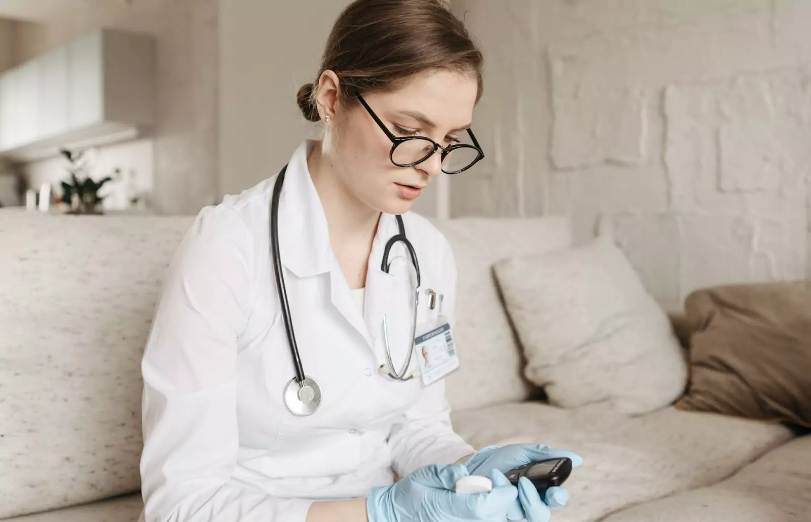 a doctor checking the results on a glucose monitor