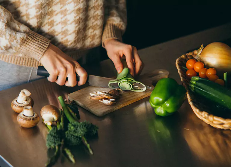 someone chopping some vegetables