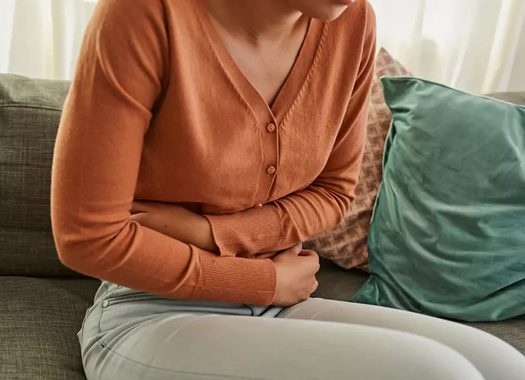 Person holding abdomen in pain