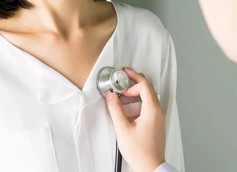 Doctor auscultating heart sounds on patient