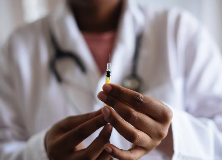 a doctor holding up a needle