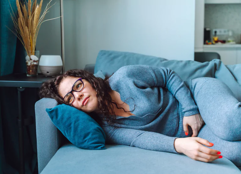 a woman lying down on the couch
