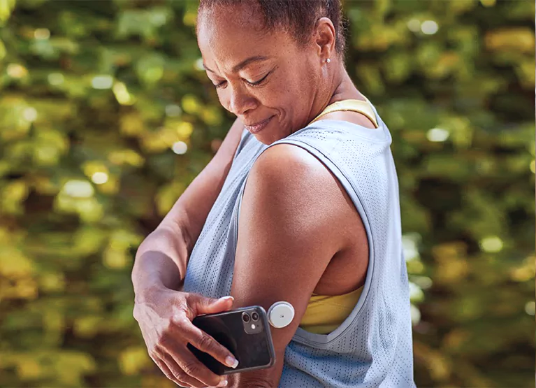 a woman scanning her cgm