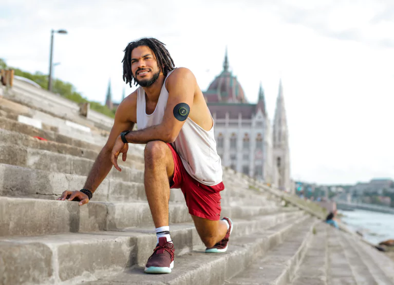a man wearing a CGM and exercising