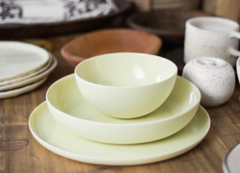 a few empty yellow plates and bowls