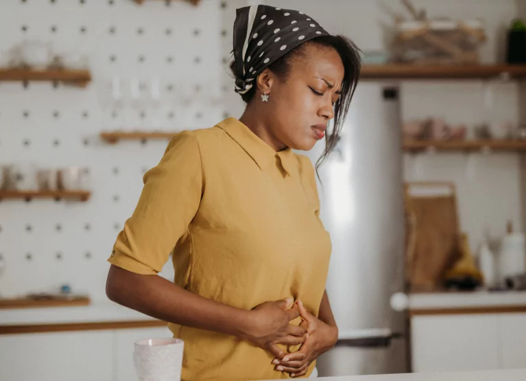 Woman clutching her stomach in pain