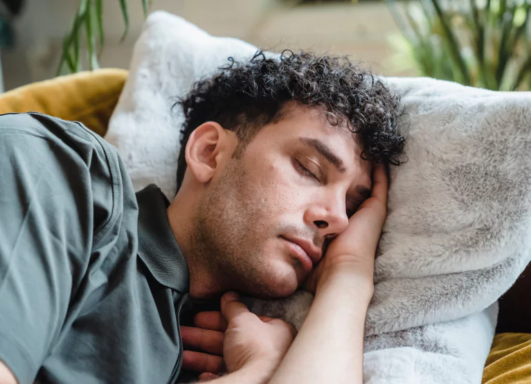 Close up of man sleeping on couch