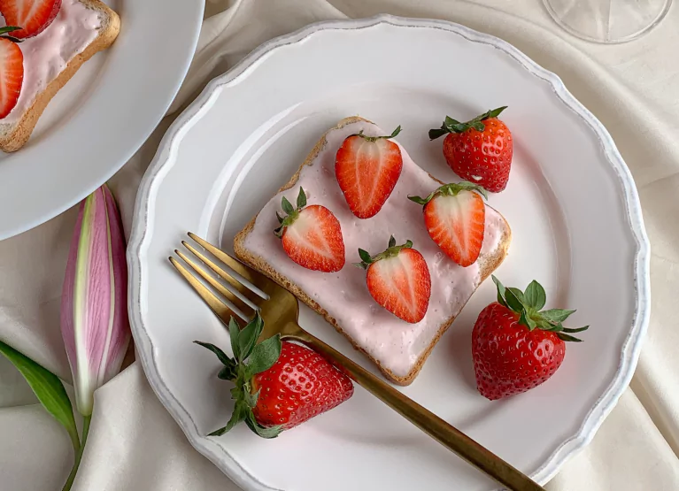 Plate of toast with jam and strawberries