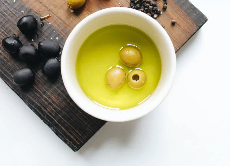 Bowl with olive oil and olives
