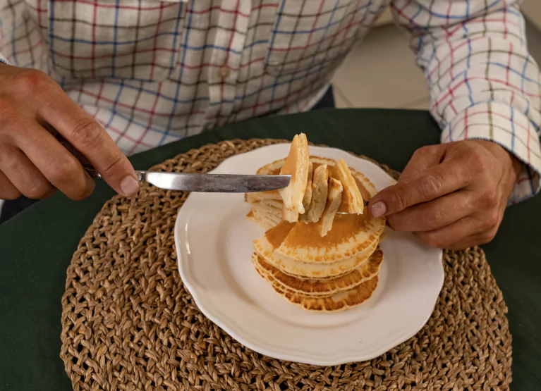 someone eating a stack of pancakes