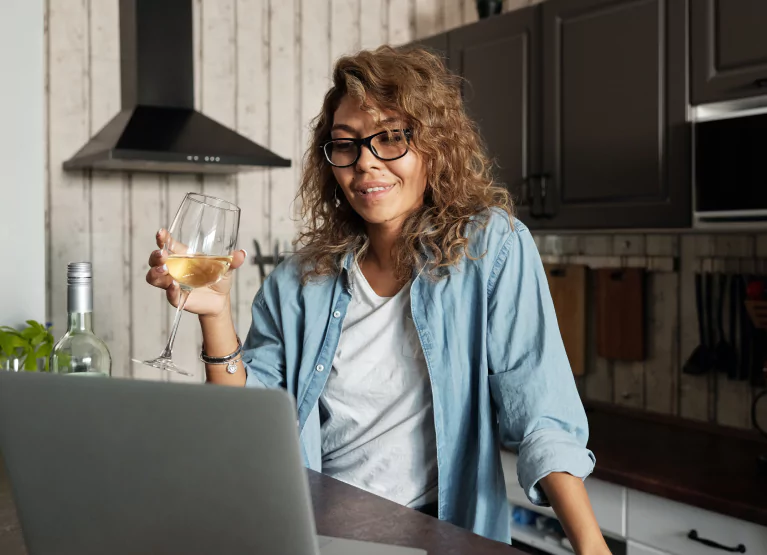 a woman having a glass of wine