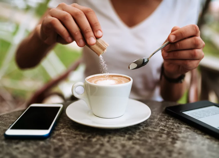 Person mixing splenda into coffee
