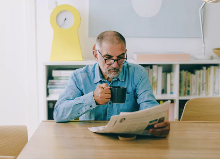 a man drinking a coffee while sitting down