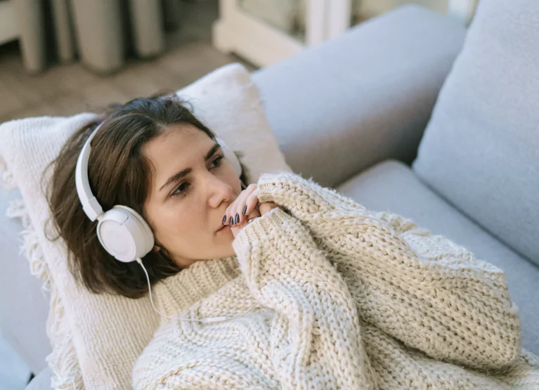 a girl listening to music on the couch