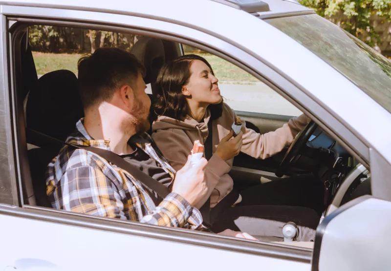 two people taking a roadtrip with snacks