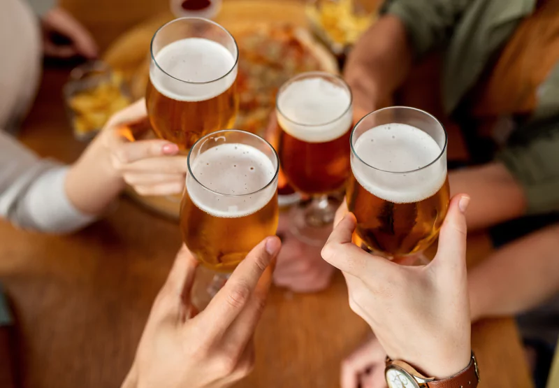 people with beer in glasses