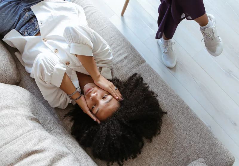 a lady laying on a therapist's couch