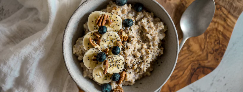 A bowl of chia seed pudding topped with bananas, blueberries and sliced bananas