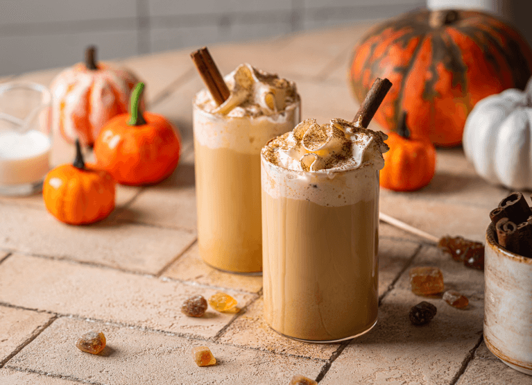 two coffee mugs and halloween decor