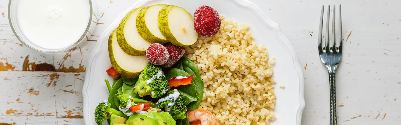 a plate of porridge, veggies and fruits
