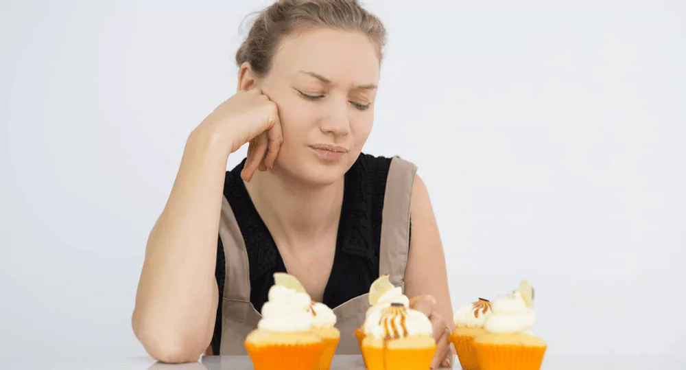 a person eating muffins looking irritated