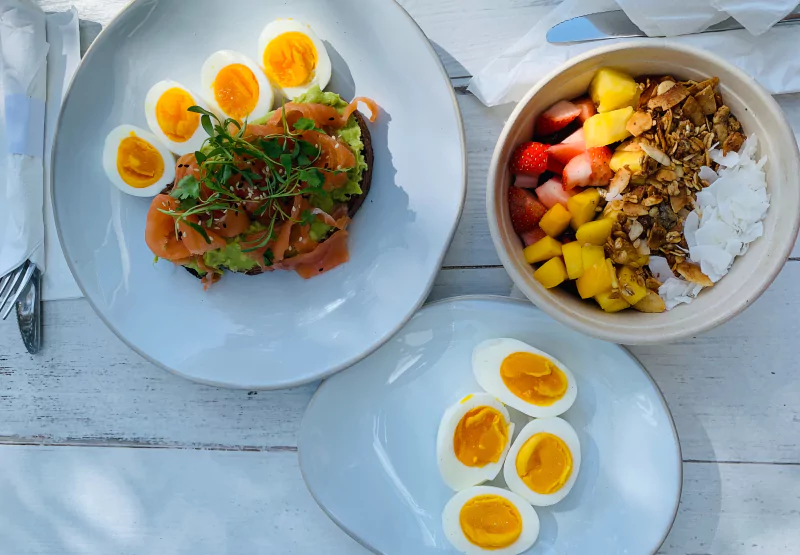 plates of eggs, toast, and an acai bowl