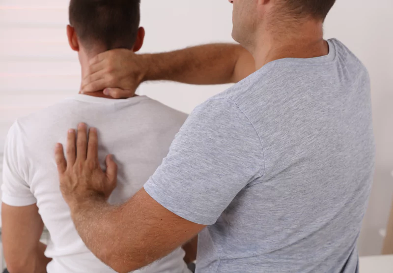 a chiropractor working with a patient