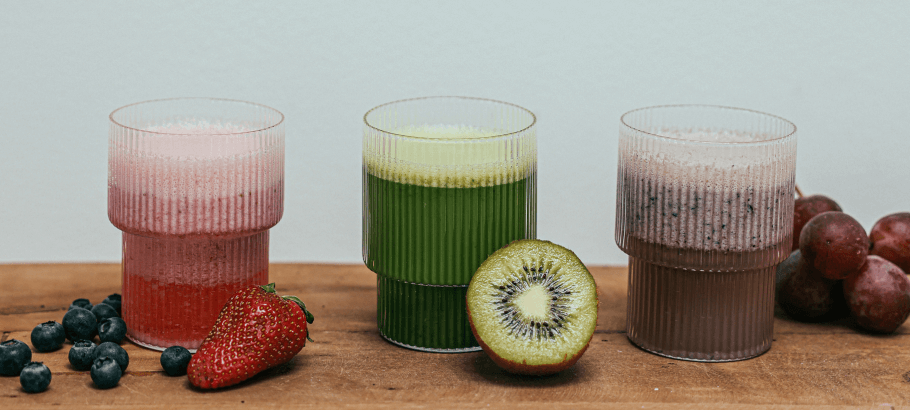 glasses of fruit juice and fresh fruit