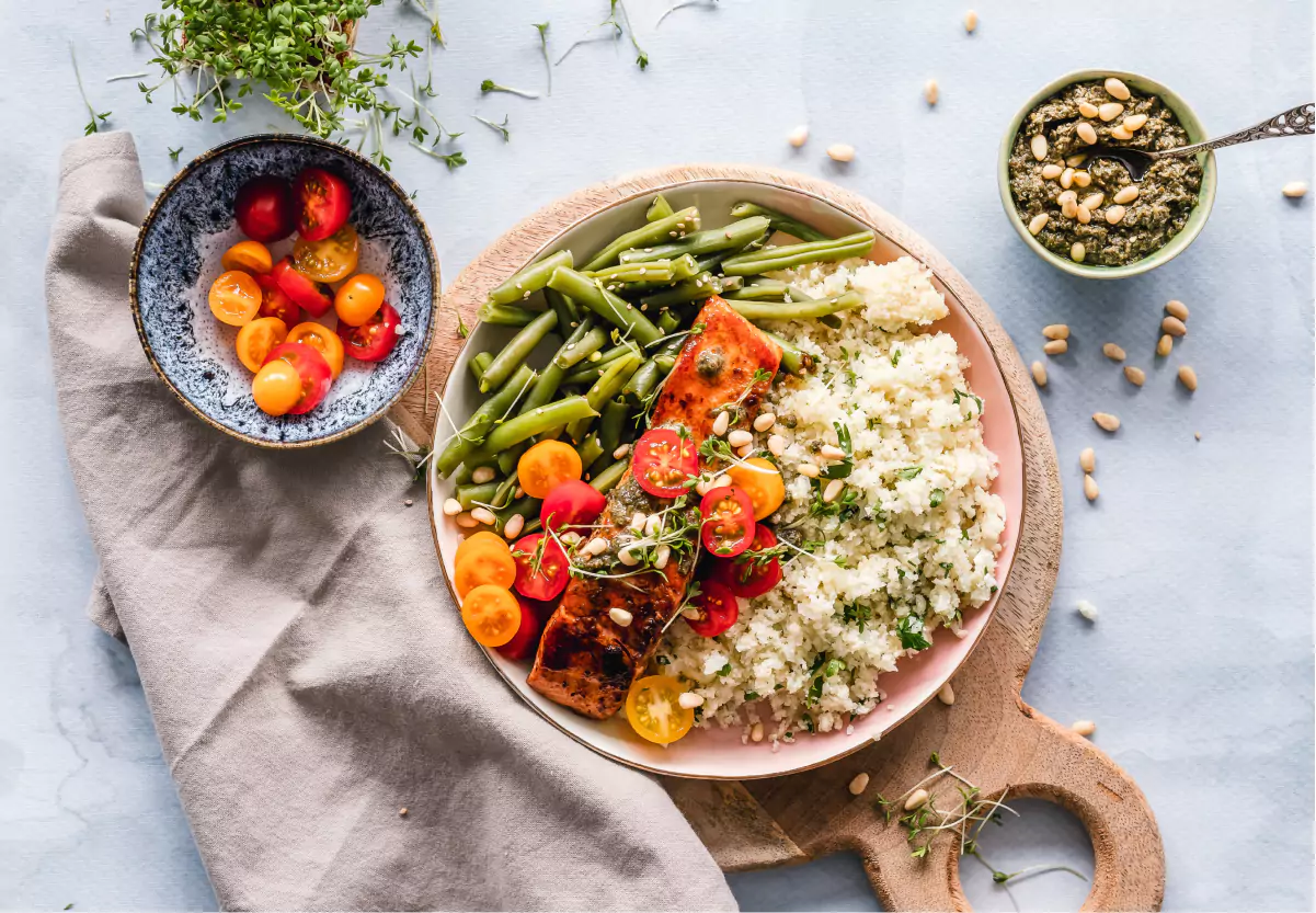 a plate of salmon and veggies