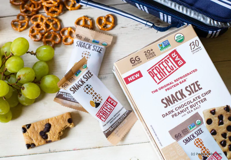 Perfect snack size bars surrounded by grapes and pretzels